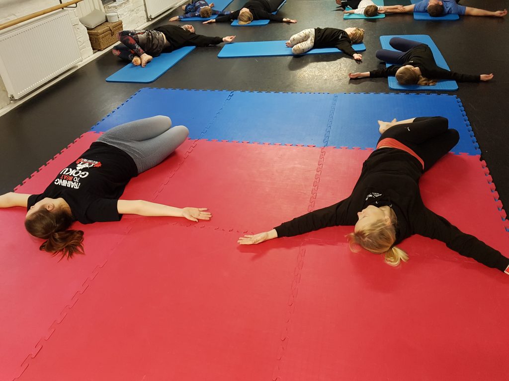 Photo of people doing a back stretch in an Active-Eat Yoga class