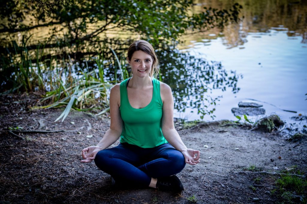 Photo of Jenny oakenfull sitting my a lake in a green top