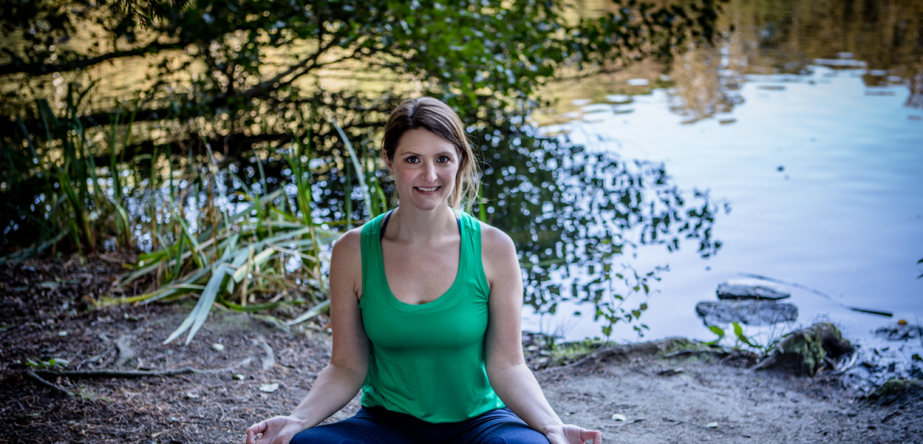 Photo of Jenny oakenfull sitting my a lake in a green top